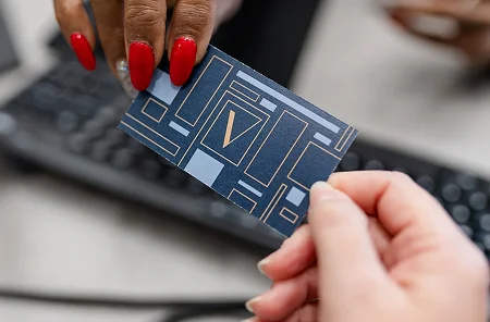 Person holding a credit card with an V Dental Health logo.